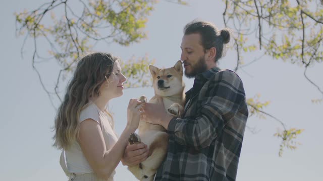 Couple Kissing Their Dog