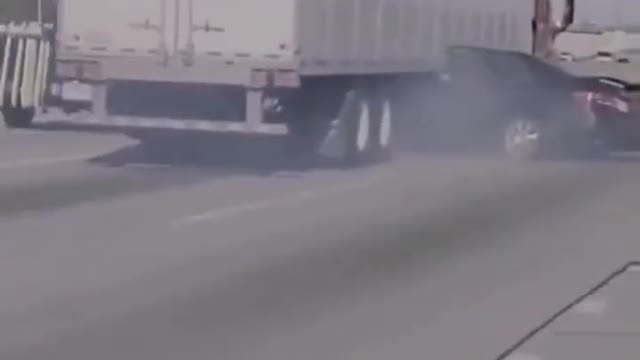 Driver desperately waves for help as a semi-truck dragged her car sideways along a Chicago highway