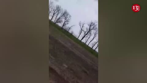 Ukrainian soldiers trying to carry their wounded fellow soldiers away from the battlefield