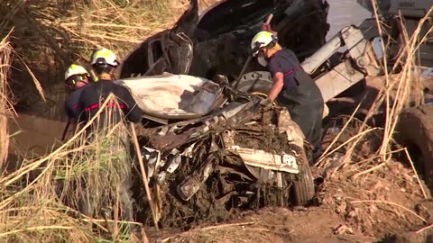 Firefighters search for flood victims in Valencia rice fields