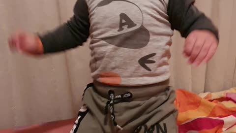 Baby is jumping on the bed