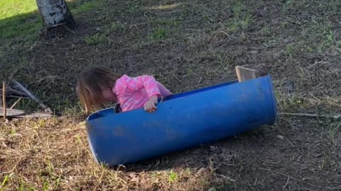 Little girl Slides Down Dirt Hill in Makeshift Sled