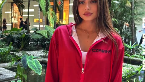 Ukrainian Czarina Anna wearing a red lounge set with cropped hoodie in Miami.