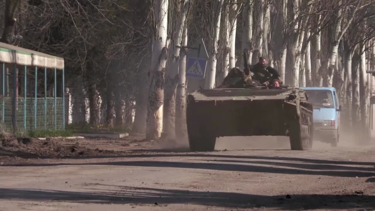 Explosions heard as people collect aid in eastern Ukraine