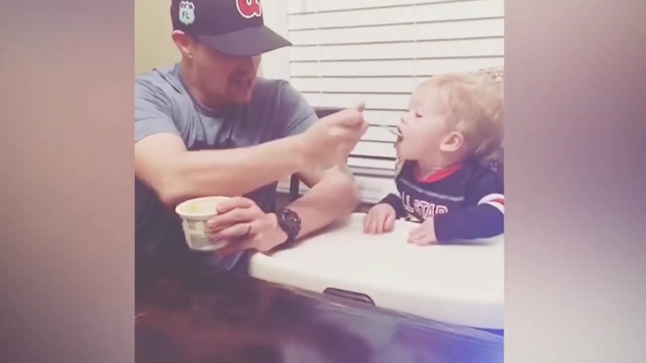 Father feeding food her baby's.