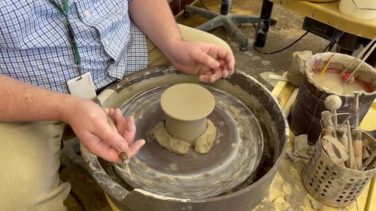 Trimming a French Butter Keeper on the pottery wheel