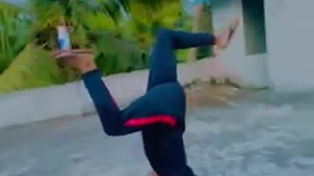 Guy Balances Can on Foot While Doing Handstand