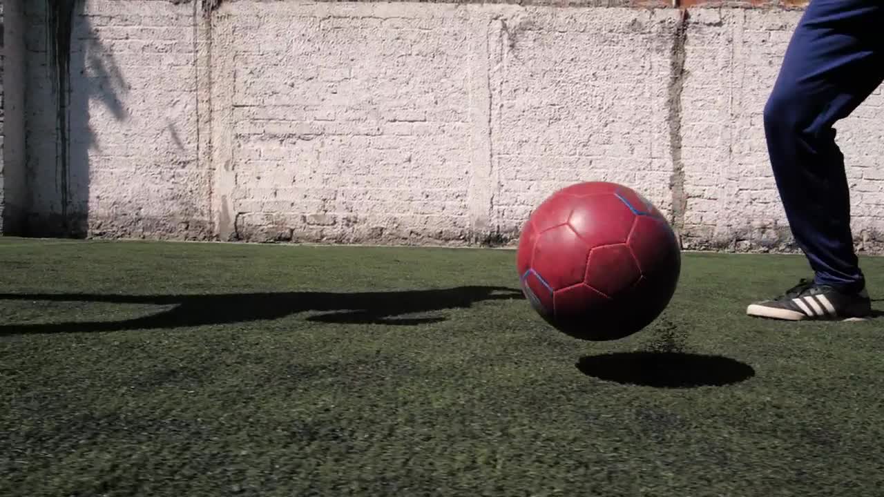 The feet of a two boys playing football soccer