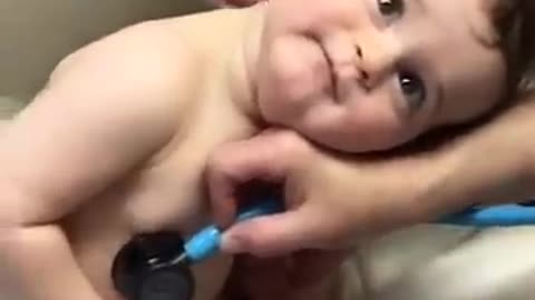 Adorable Baby Boy cuddles on nurse