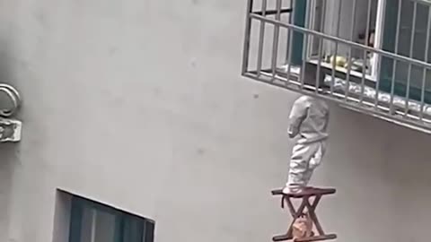 Neighbors rescue boy dangling from 4th-floor window in China