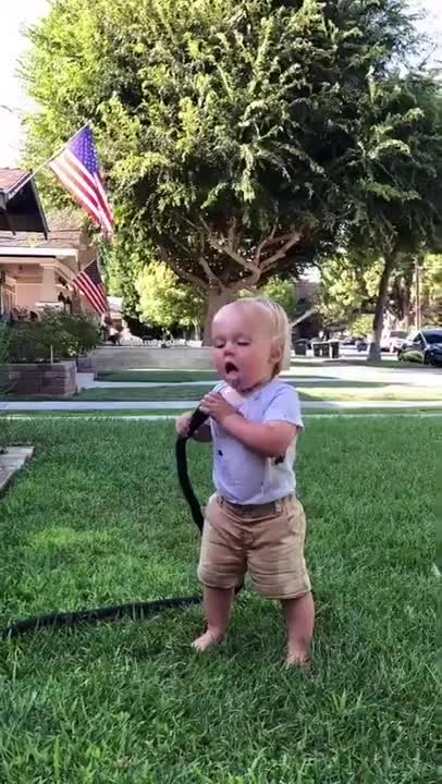 Baby drinking from hose