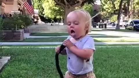 Baby drinking from hose