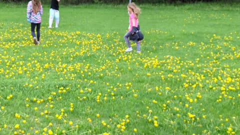 The girls flying a kite with a friend