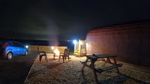 Night lapse. Glamping pod with a campfire