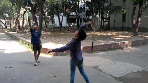 Two boys are playing Badminton