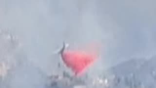 A plane drops retardant on The Garden Fire. 11-08-24