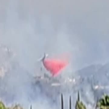 A plane drops retardant on The Garden Fire. 11-08-24
