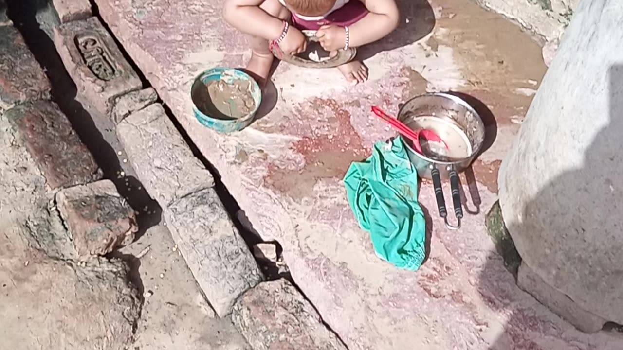 Little girl wash the tray in Indian village