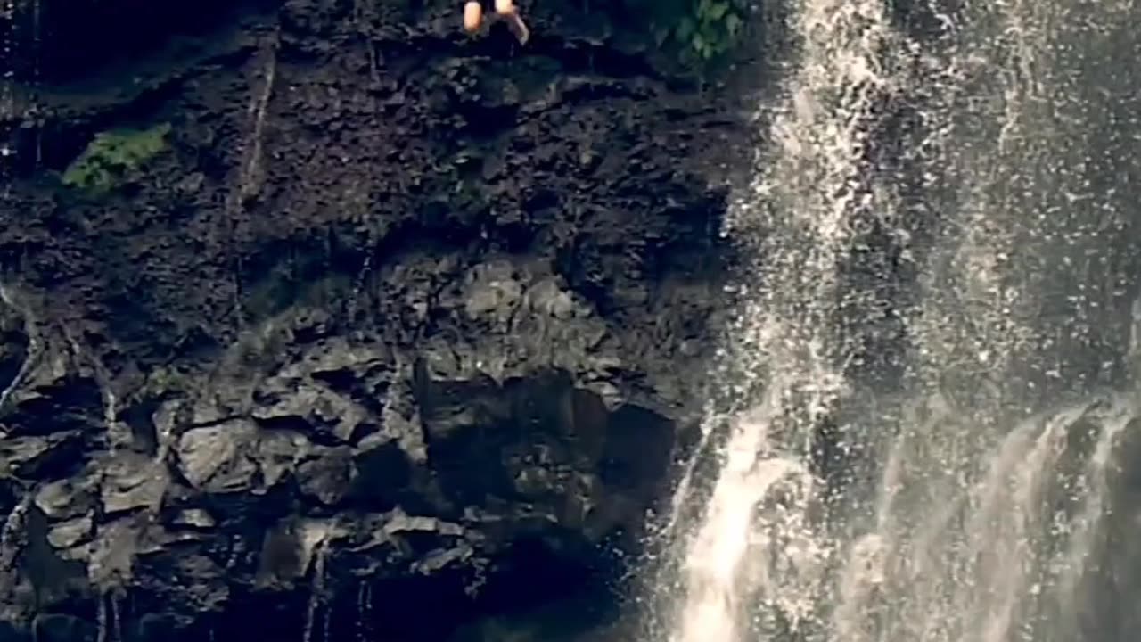 Man high jumping with flow water