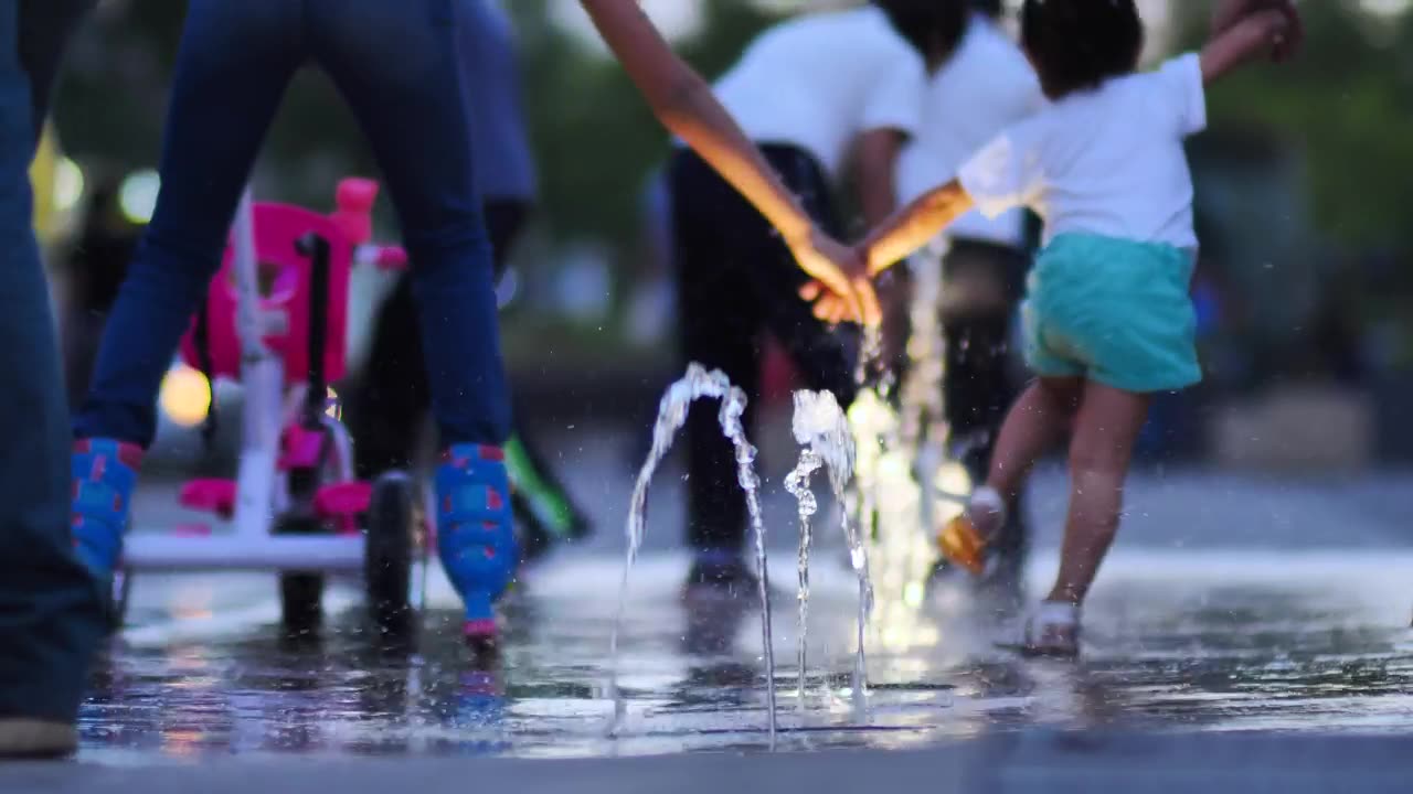 Children playing with a dancing fountain