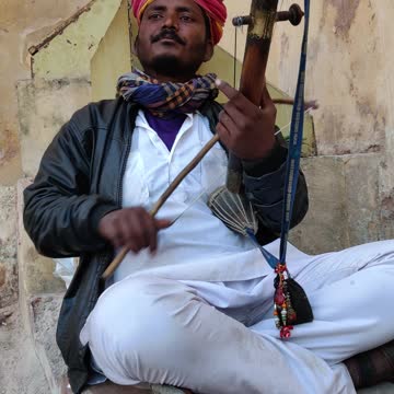 A Man Playing A Traditional Musical Instrument Of India