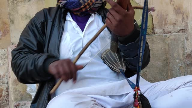 A Man Playing A Traditional Musical Instrument Of India