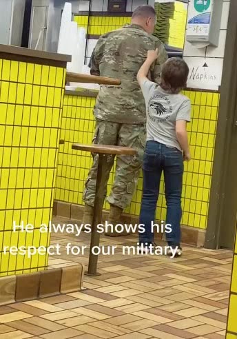 Young boy always love to show his respect for the military....