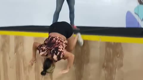 Girl Falls to the Ground Trying a Pull Over on a Trampwall