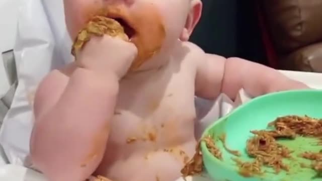 Baby gets messy and eats with her hands