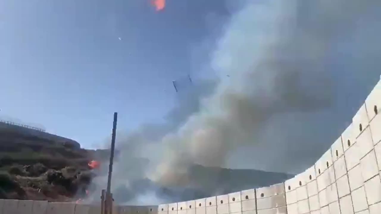 Israeli soldiers using old-school methods to clear vegetation by the Lebanese