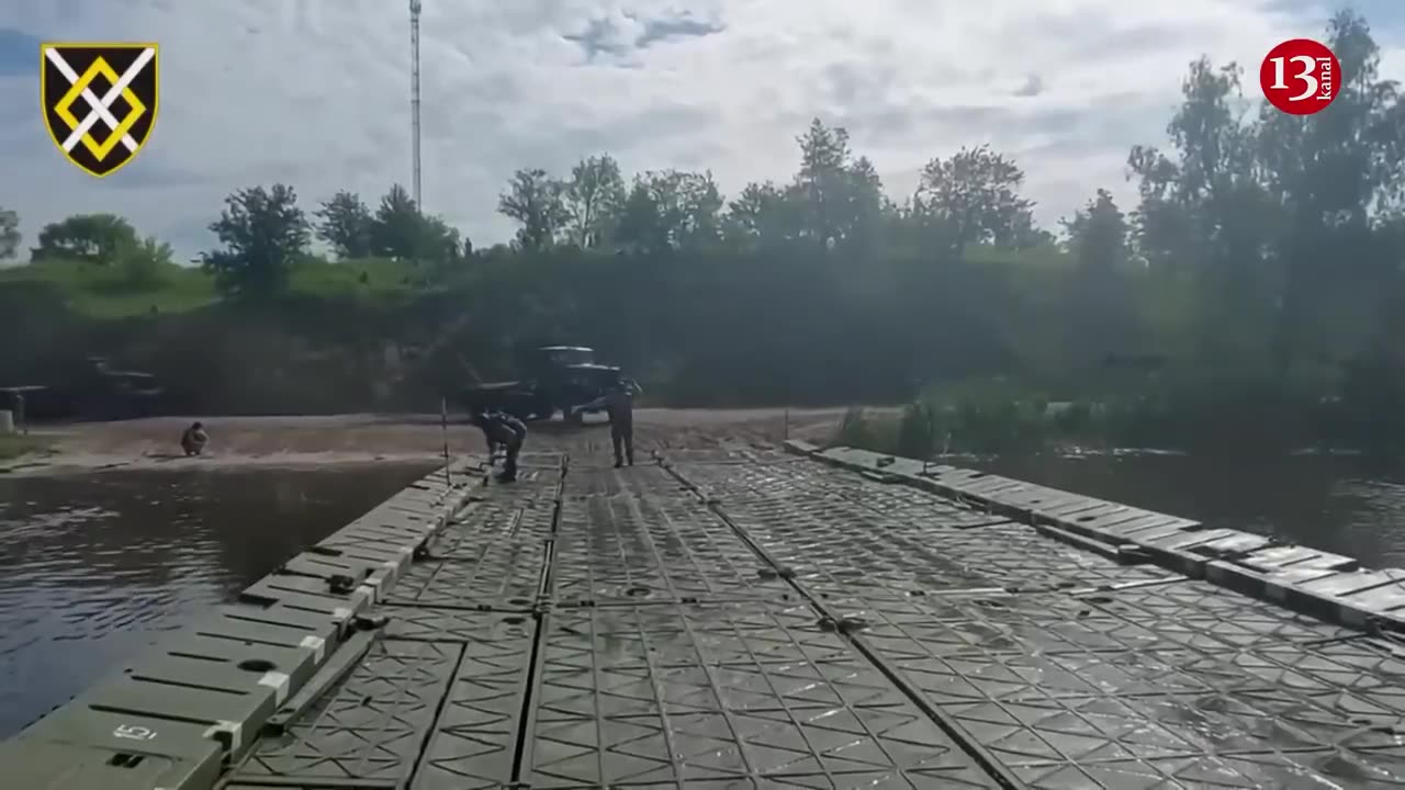 Ukrainian army prepares for attack by moving heavy equipment across river with pontoon bridges