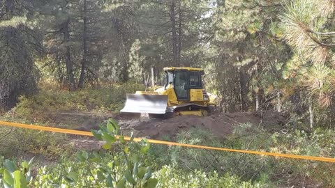 Dozer Cuts a Pad at the End of a Mountain Road