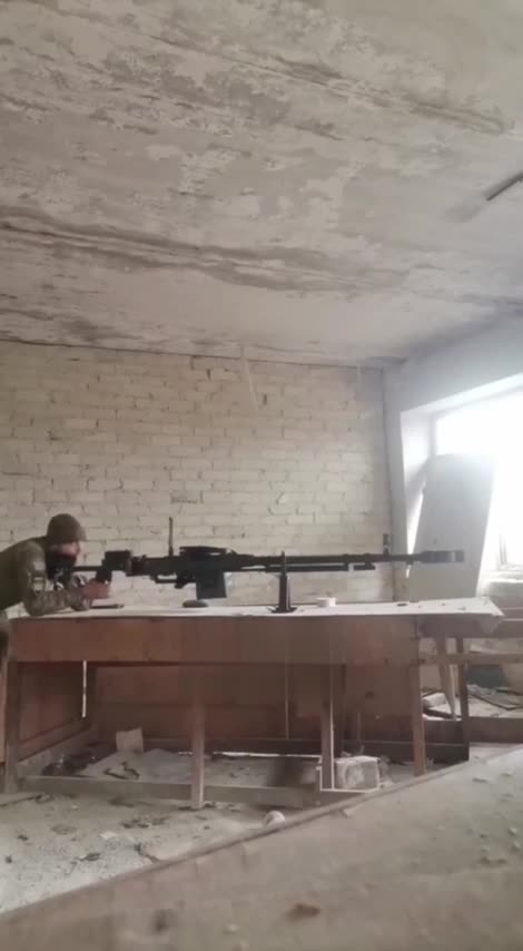 Ukranian soldier fires at Russian positions from a massive Kord heavy machine gun