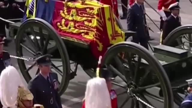 The public mourns as they watch Queen Elizabeth's coffin