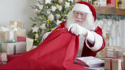 Santa Claus Putting Boxes Of Gifts In A Sack