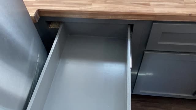 Carpenter Showcases Sliding Drawer Near Fridge