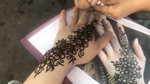 Mama, look at my henna tattoo.