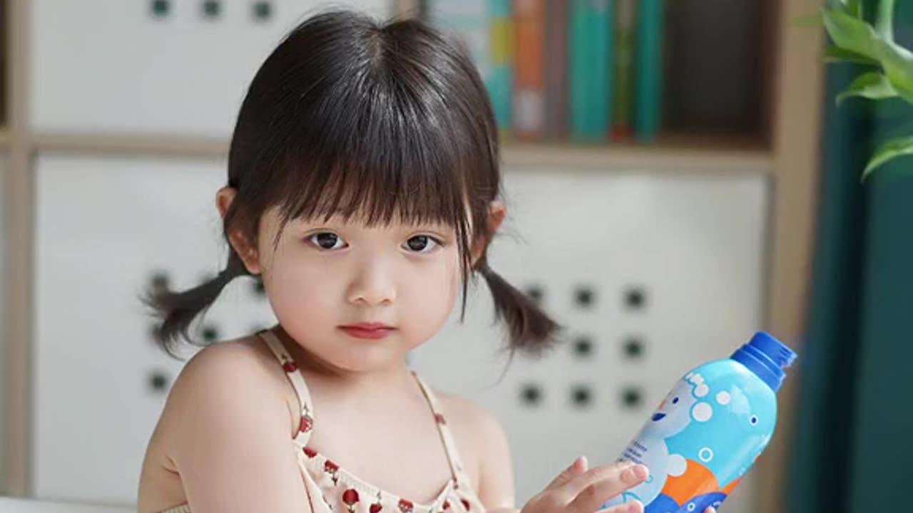 Cute baby playing with bath soap