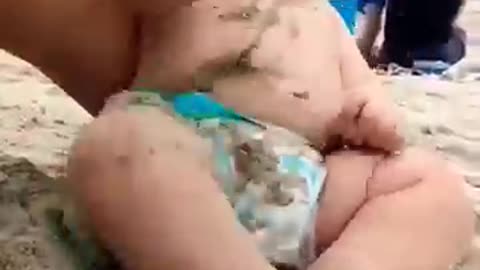 Funny baby reaction on the beach