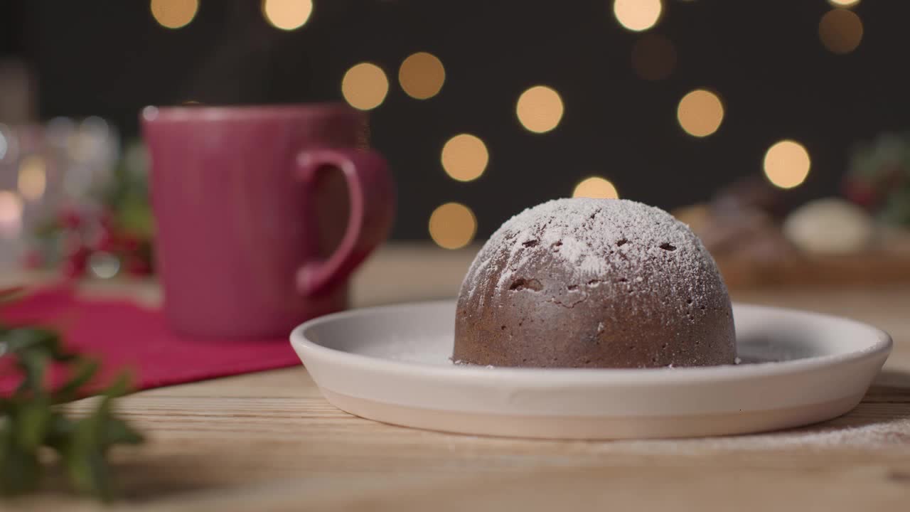 Tracking Shot Pulling Away from Christmas Pudding On a Rustic Table