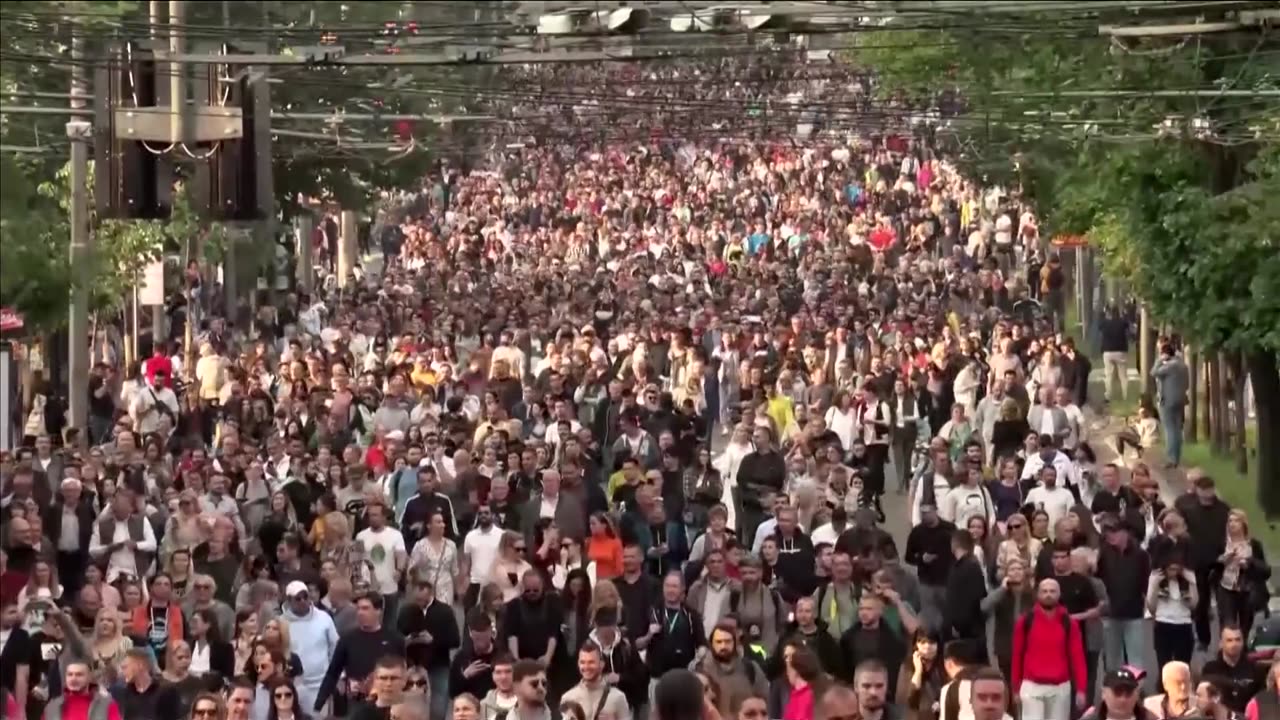 Tens of thousands march in Belgrade after mass shootings