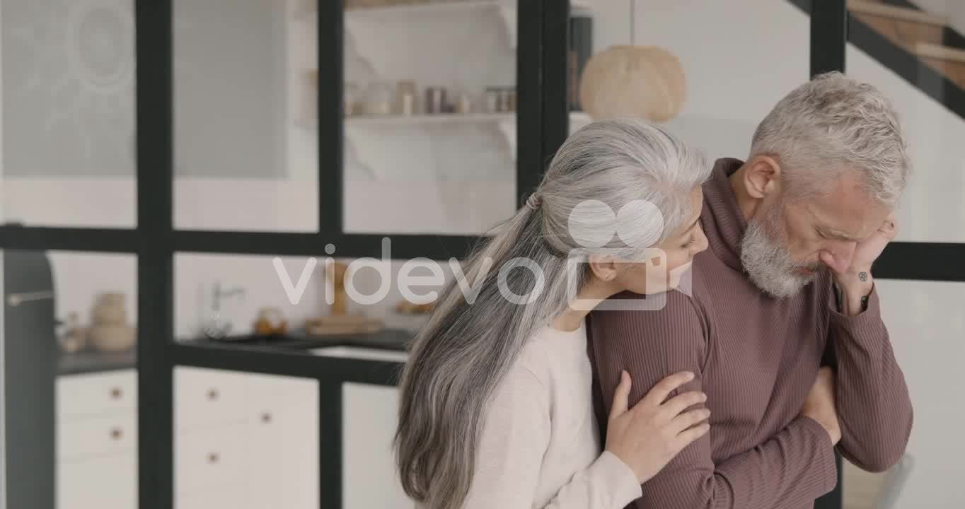 Middle Aged Man Having Headache At Home While His Wife Trying To Comfort Him