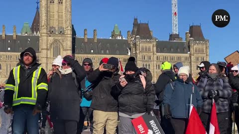 Freedom Convoy Trucker leads crowd in round of O Canada at Parliament Hill.