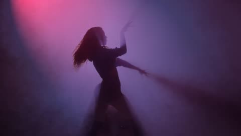 woman dancing in the fog