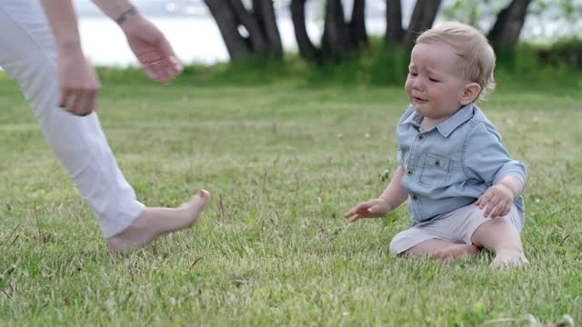 A Mother Training Her Young Child To Walk In The Grass The Park