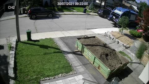 Garbageman Dumps Recycle Bin Into Trash Truck While Collecting Waste in Neighborhood