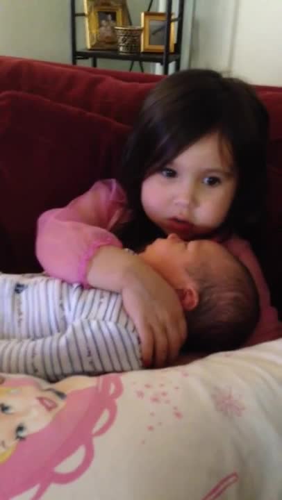 Big sister sings Let It Go to newborn brother
