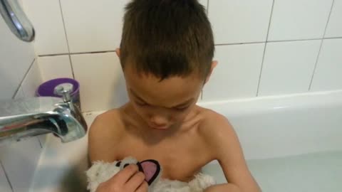 Sensitive Boy Bathes His Teddy Bear 