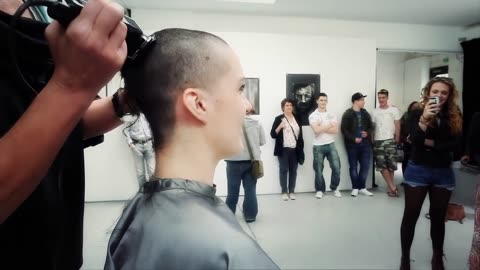 Girl shaves her head to raise money for travel