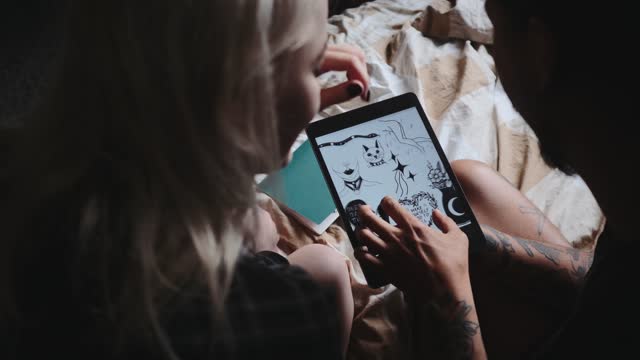 Couple Discussing about a Tattoo Design